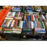 Four trays of hardback books,