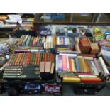 Four trays of hardback books by various authors to include Jeffrey Archer