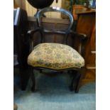 An early 20th century stained beech open arm chair