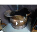 A copper coal scuttle