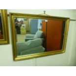 An ornate gilt framed rectangular mirror