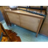 A mid 20th century teak sideboard with two sliding doors