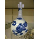 A Japanese blue and white dragon design bud vase
