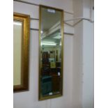 A gilt framed rectangular bevelled glass mirror