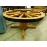 A table in the form of a replica wheel on a turned column (no glass)