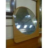 A circular mirror on a wooden easel base