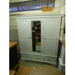 An ivory triple wardrobe with drawer base (17.