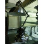 A modern brushed metal angle poise style lamp