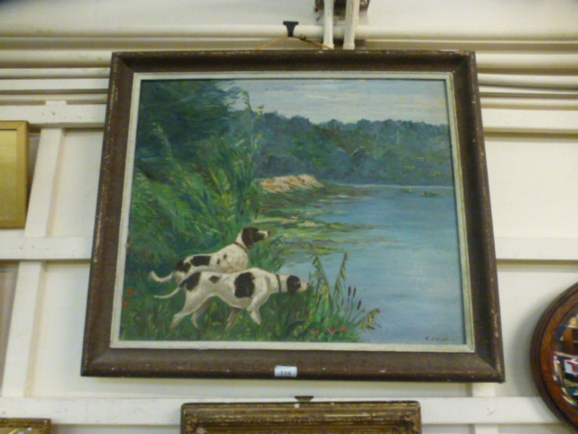 A framed oil on board of dogs looking over a lake, signed E.