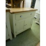 An oak topped side cabinet with single drawer over two cupboard doors (40.