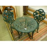 A cast aluminium and green painted bistro set