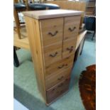 A modern pine chest of a bank of four drawers above three drawers