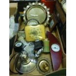 A tray containing clocks, cigarette lighters etc.