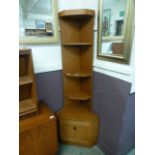 A mid-20th century design corner cupboard having open storage above cupboard door