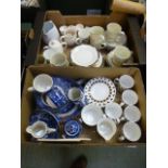 Two trays of ceramic tableware to include plates, cups, saucers etc.