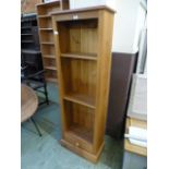 A modern pine slim bookcase
