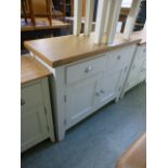 An oak topped two drawer over two door cabinet (19.