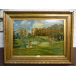 A gilt framed oil on board of cows in field signed W.