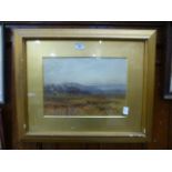 A framed and glazed watercolour of countryside scene,