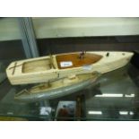 A hand crafted wooden boat together with a clockwork submarine
