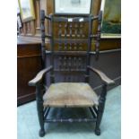 An early 20th century oak and ash spindle back open arm chair