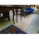 A large rectangular beige rug CONDITION REPORT: 352 cm x 300 cm Some stains,