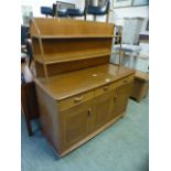An Ercol dresser having three drawers above cupboard doors with a raised back