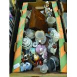 A tray containing an assortment of ceramic figures, mugs etc.