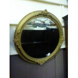 A gilt framed circular mirror