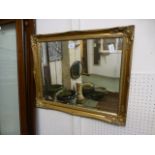 A gilt framed bevel glass ornate wall mirror