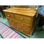 A modern pine chest of two short over two long drawers