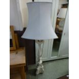A cream and painted decorative standard lamp with shade