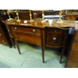 A reproduction mahogany breakfront sideboard having a centre drawer above large drawer flanked by