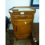 A small wooden office cabinet having single drawer above cupboard door