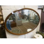 An oak framed oval bevel glass wall mirror