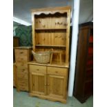 A modern pine dresser having plate rack to top,