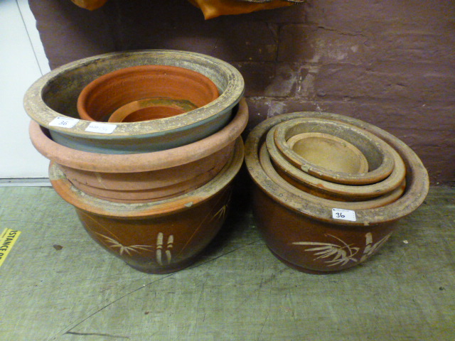 A selection of earthenware and terracotta plant pots some being glazed