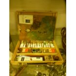 An artists pallet together with a selection of oils etc.