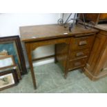 An early 20th century oak desk having a bank of three drawers with pullout slide