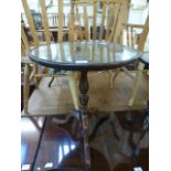 A mahogany circular topped single pedestal wine table