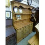 An early 20th century and later pine dresser,