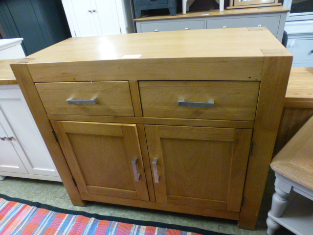 An oak sideboard with two drawers over two doors (66.