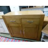 An oak sideboard with two drawers over two doors (66.