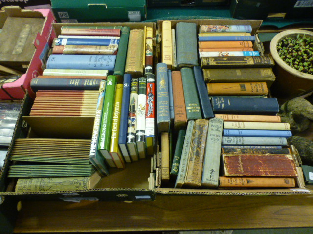 Two trays of hardback books by various authors