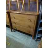 A mid 20th century walnut three drawer chest,