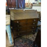 An 18th century oak fall front bureau having a part fitted interior with four graduated drawers