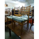 A set of four mid 20th century beech framed dining chairs