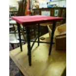 A 19th century occasional table with a red velvet top on turned legs and stretchers