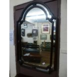 A reproduction wooden framed arch top wall mirror