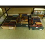 Three trays of hardback books,